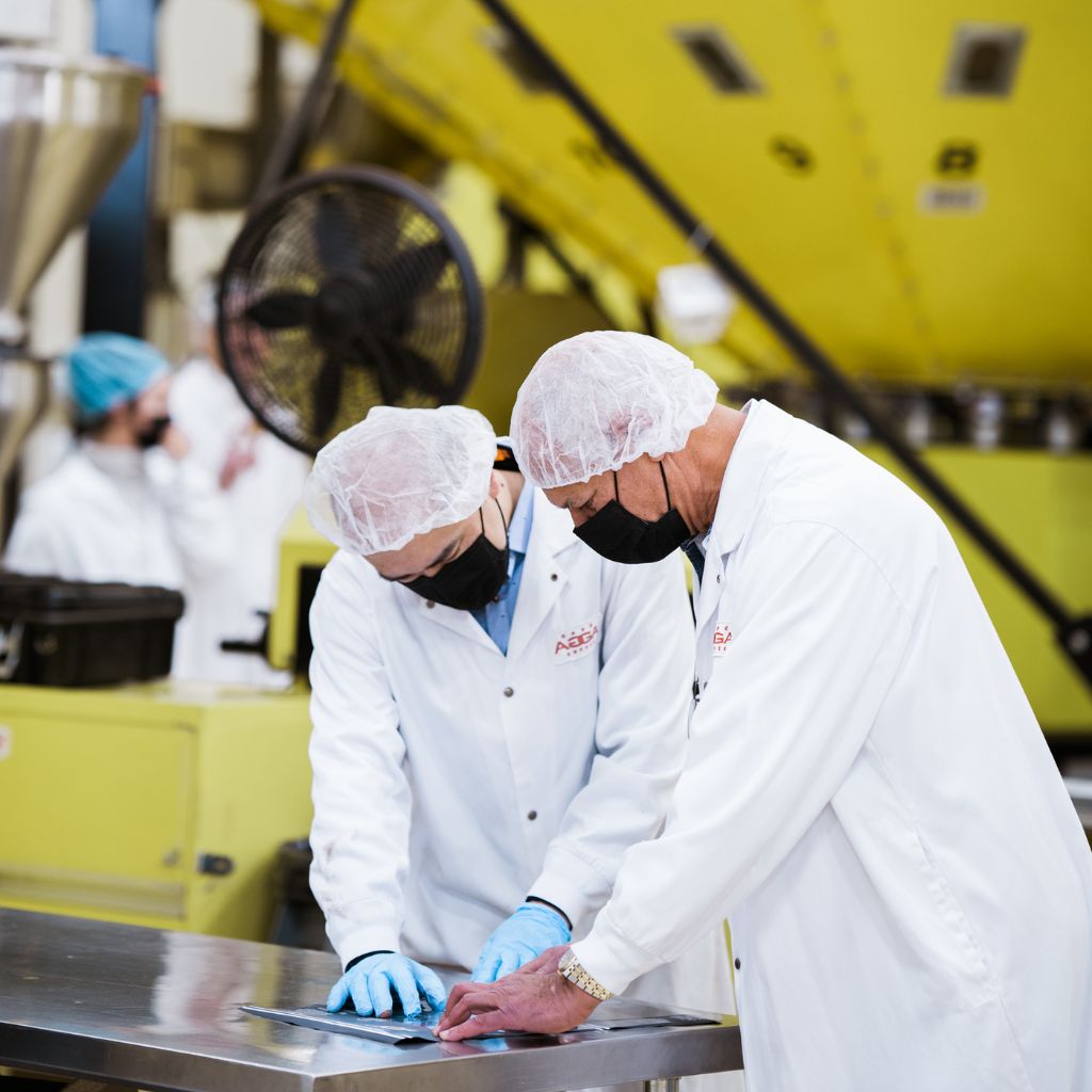 Two baristas working on quality control in the factory